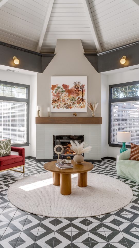 a living room with a fireplace and black and white tile at The Evaline